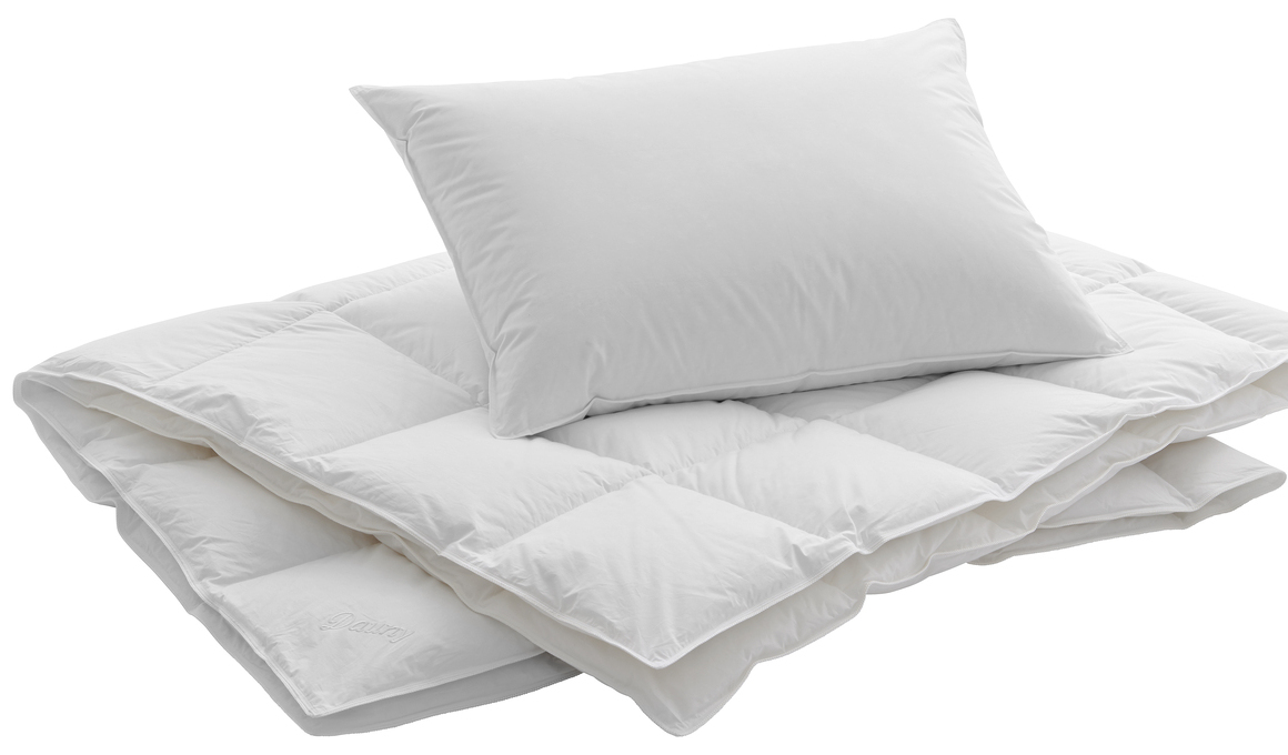 Frisch gepflegtes weißes Duvet mit Kissen – Symbol für hygienische Bettwarenpflege und die Empfehlung, Decken und Kissen mindestens einmal jährlich zu waschen.