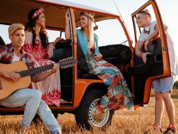 Junge Menschen entspannen am Camper in der Abendsonne – Symbolbild für erholsamen Schlaf auf Reisen und Tipps für guten Schlaf im Urlaub.