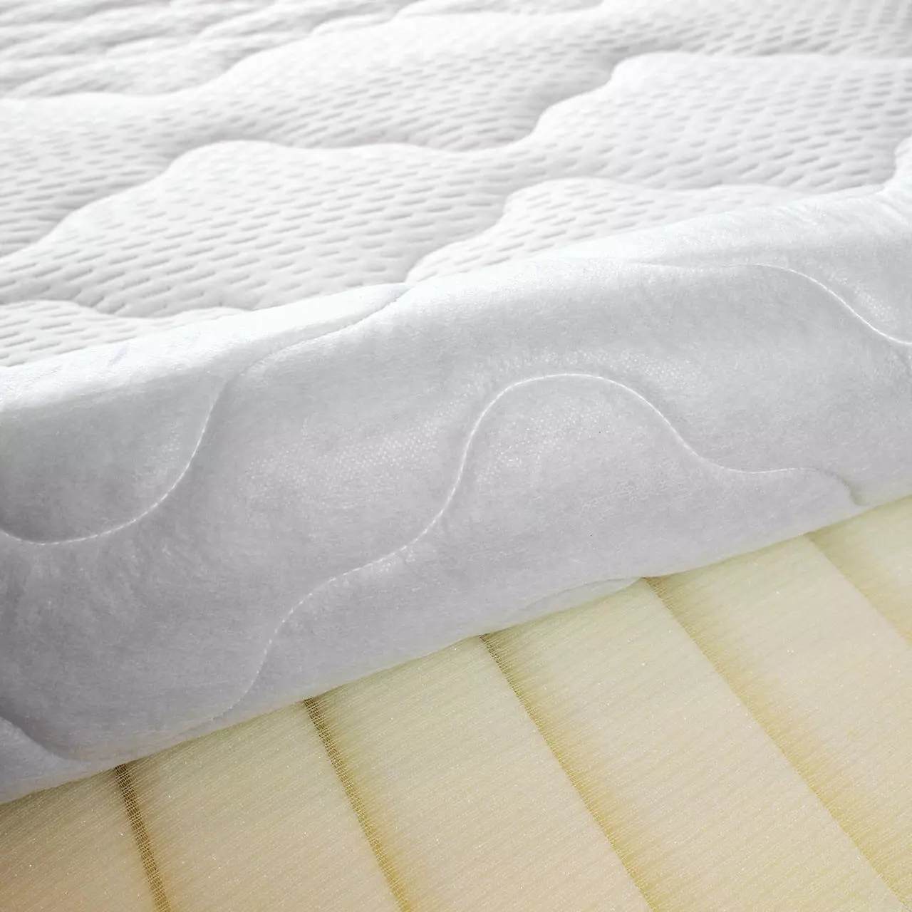 Open cover with view of the mattress core of the Wash Star mattress, white mattress cover