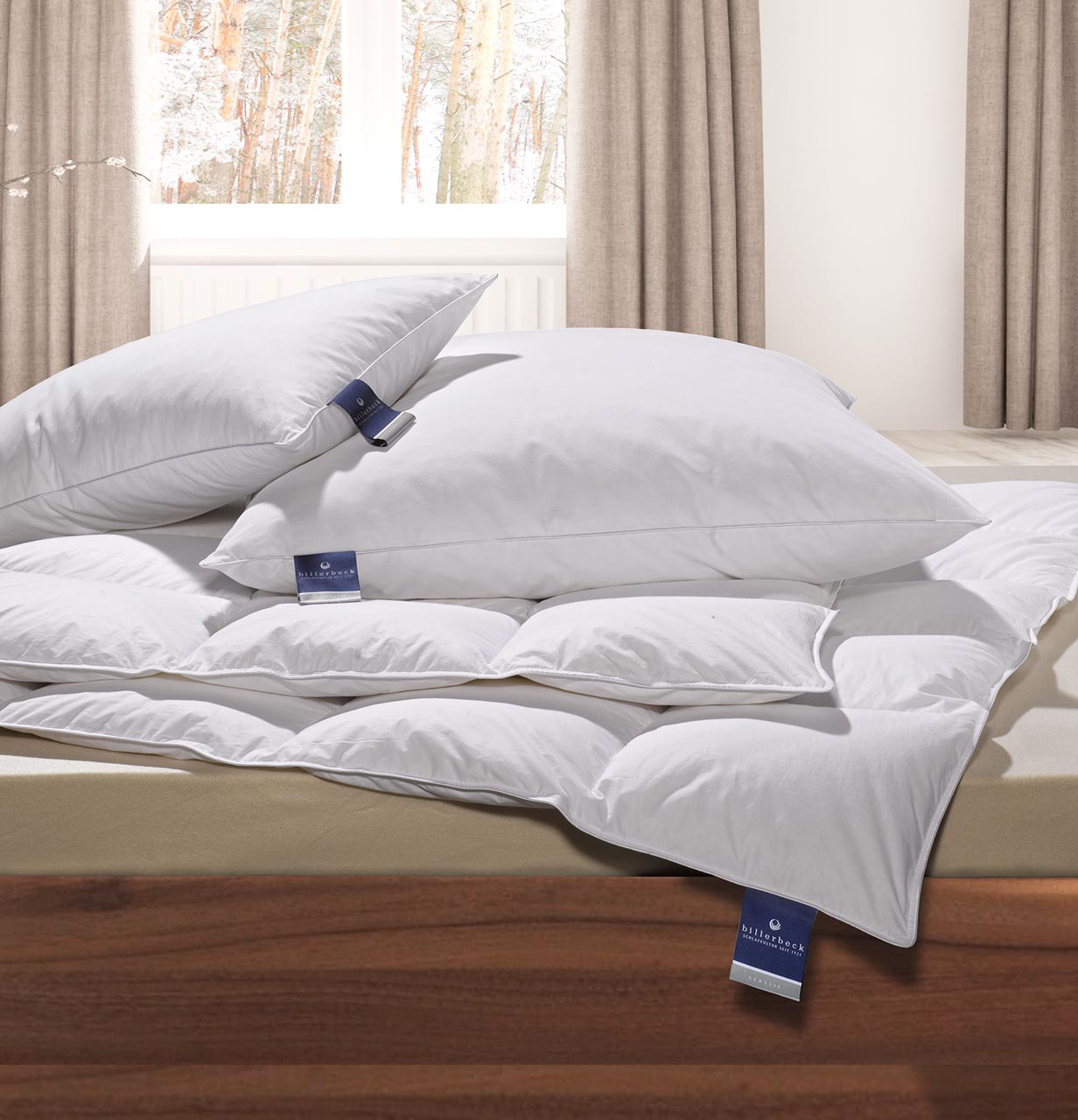Down pillow ALMIRA® billerbeck Almira pillow and duvet set arranged on a bed in a bright bedroom