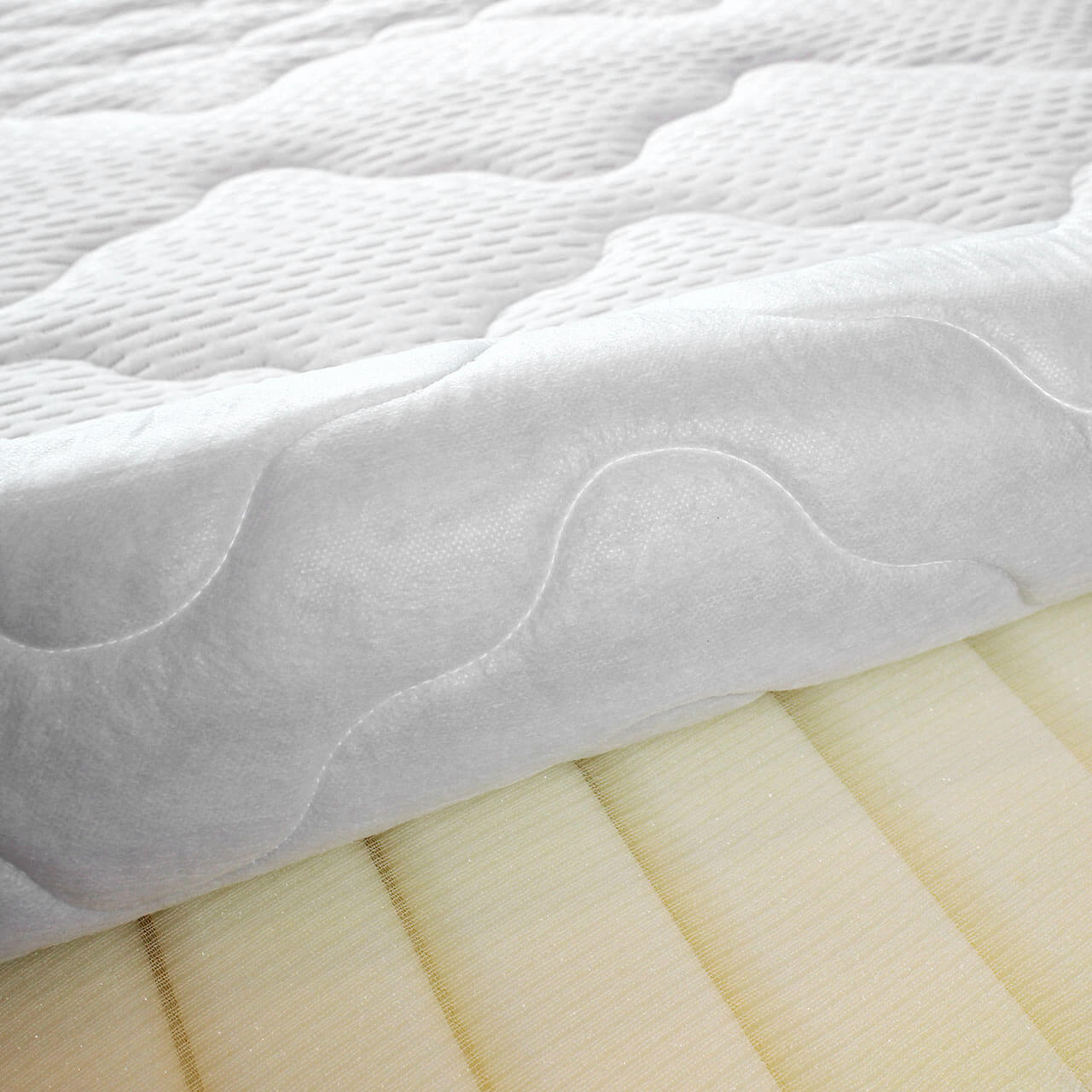 Open cover with view of the mattress core of the Wash Star mattress, white mattress cover